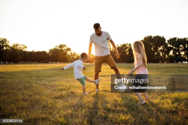 family soccer game - father and son park stock pictures, royalty-free photos & images