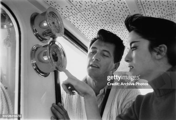 Actors Rock Hudson and Linda Cristal on board a yacht, 18th February 1960.