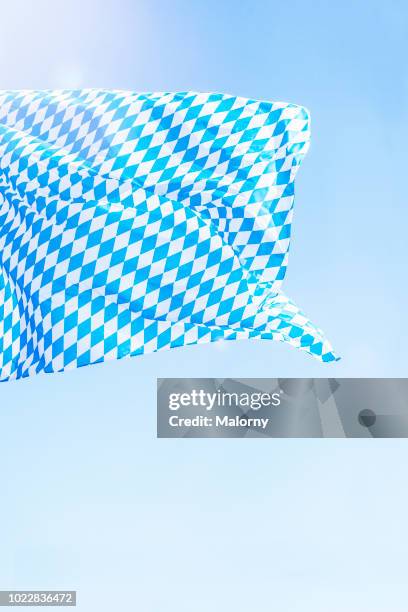 bavarian flag against clear blue sky during sunny day. germany, bavaria, munich, beer fest - bavarian photos et images de collection