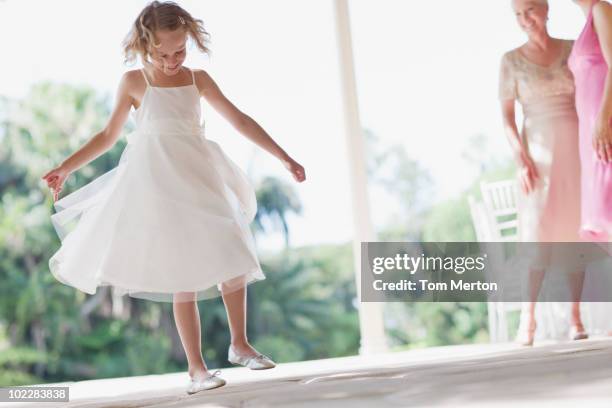 flower girl playing at wedding reception - bruidsmeisje stockfoto's en -beelden