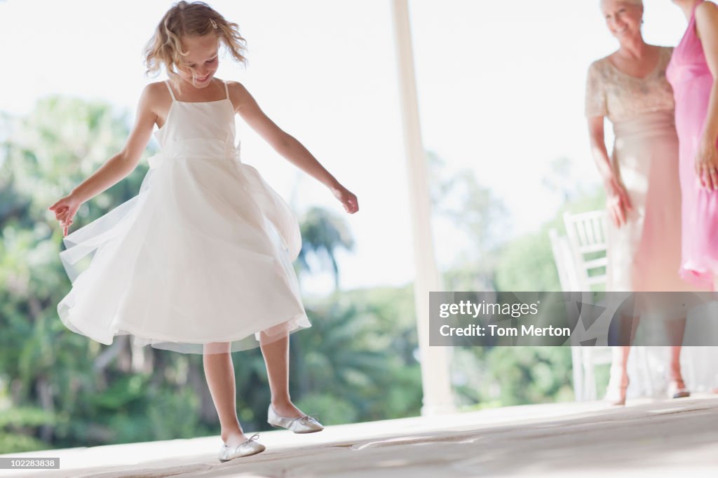 Flower girl playing at wedding reception