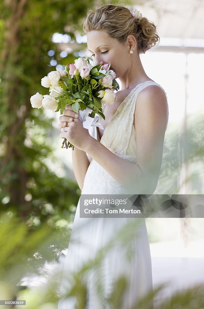 Bride smelling bouquet