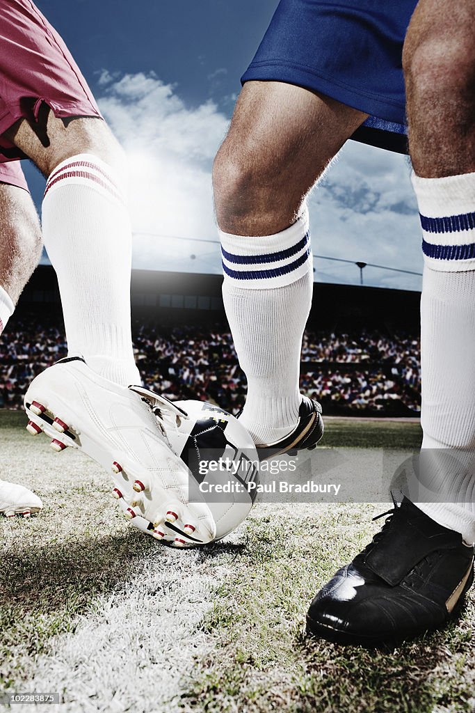 Soccer players competing for soccer ball