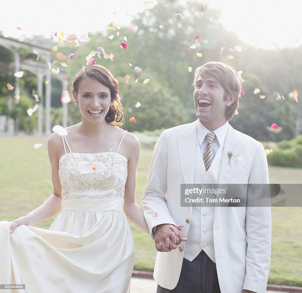 Bride and groom holding hands