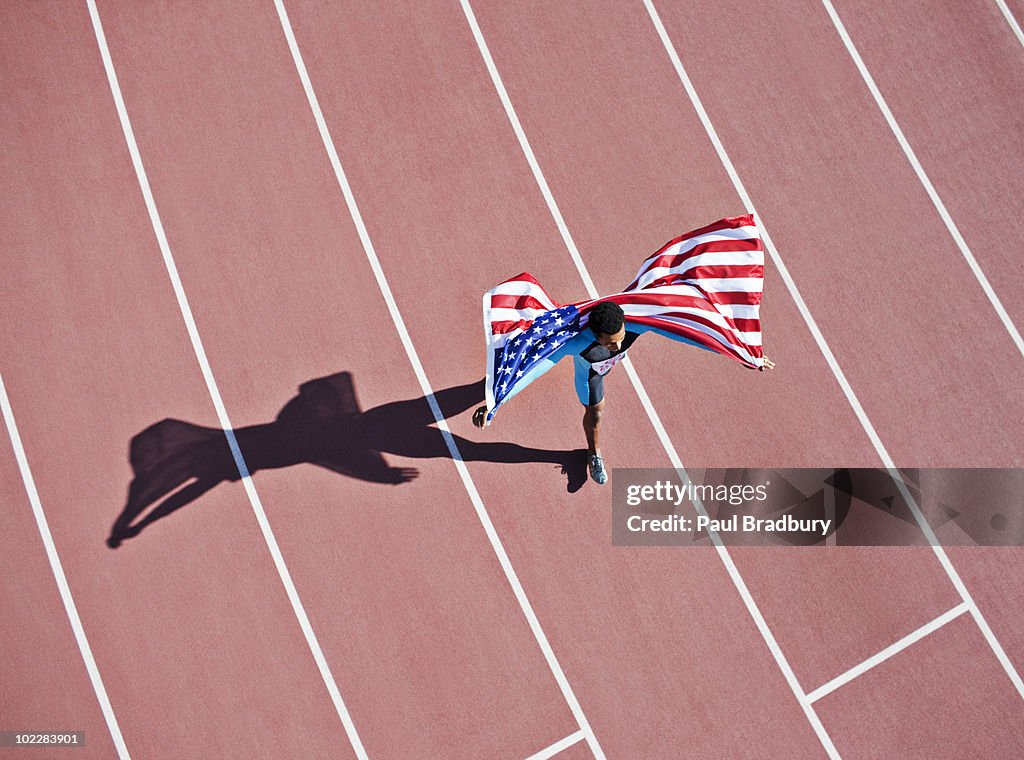Runner celebrating on track with American flag