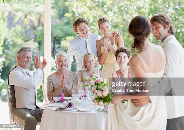 family celebrating at wedding reception - wedding reception stock pictures, royalty-free photos & images