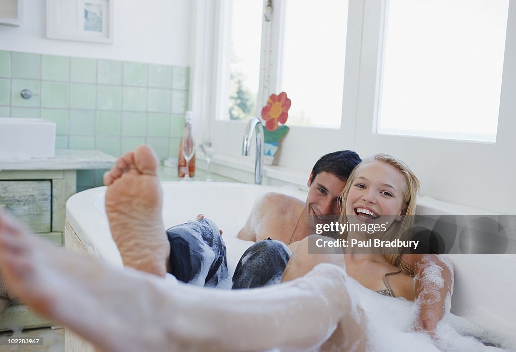 Dressed couple in bubble bath