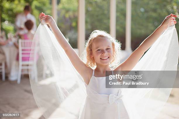 flower girl with arms outstretched - flower girl stock pictures, royalty-free photos & images