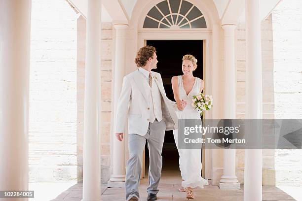 bride and groom holding hands - bride walking stock pictures, royalty-free photos & images