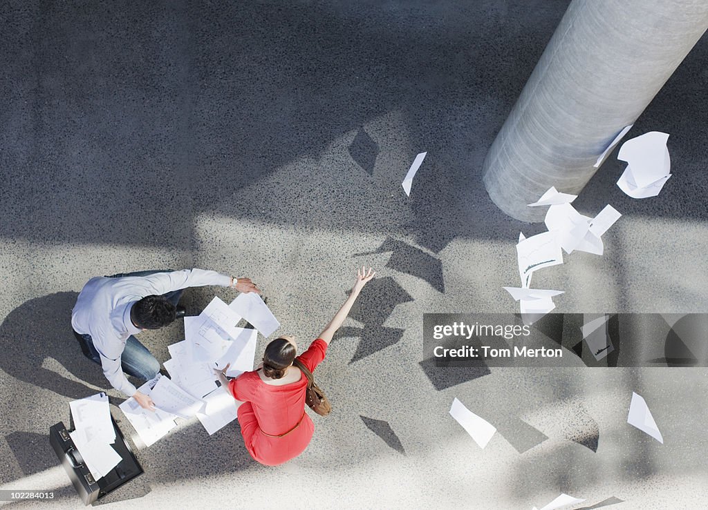 Business people dropping paperwork