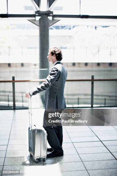 uomo d'affari in attesa con una valigia in stazione ferroviaria - sydney airport foto e immagini stock