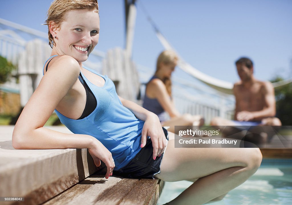 Woman reclining at swimming pools edge