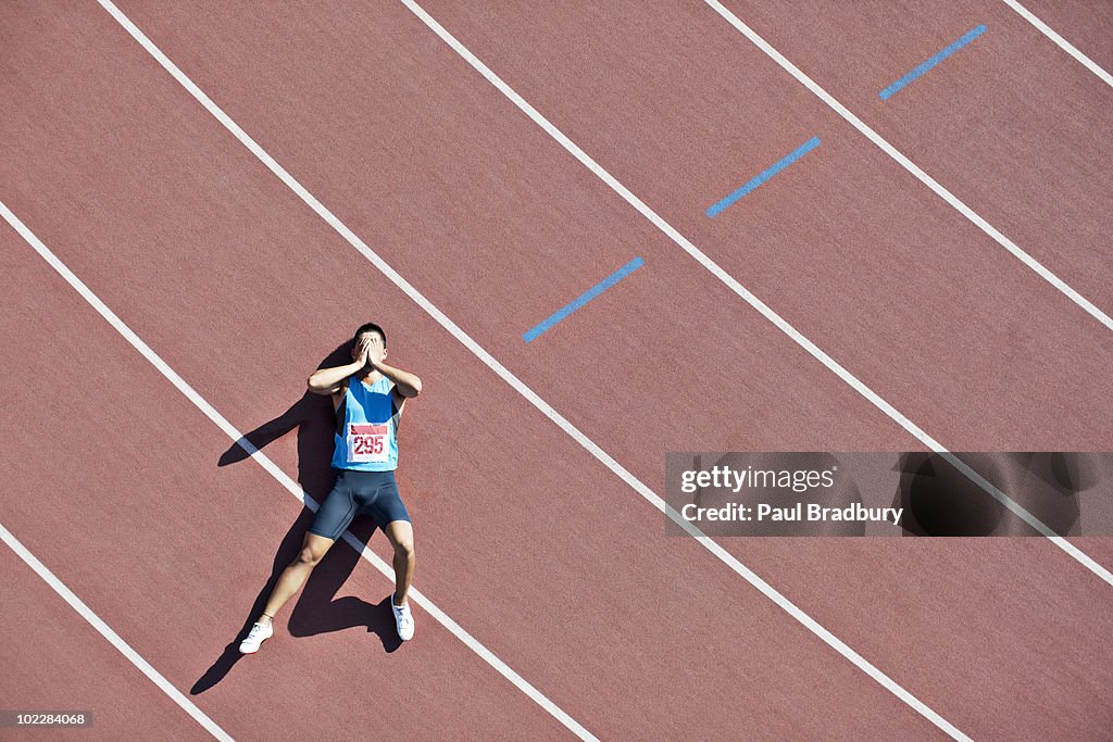 Tired runner laying on track