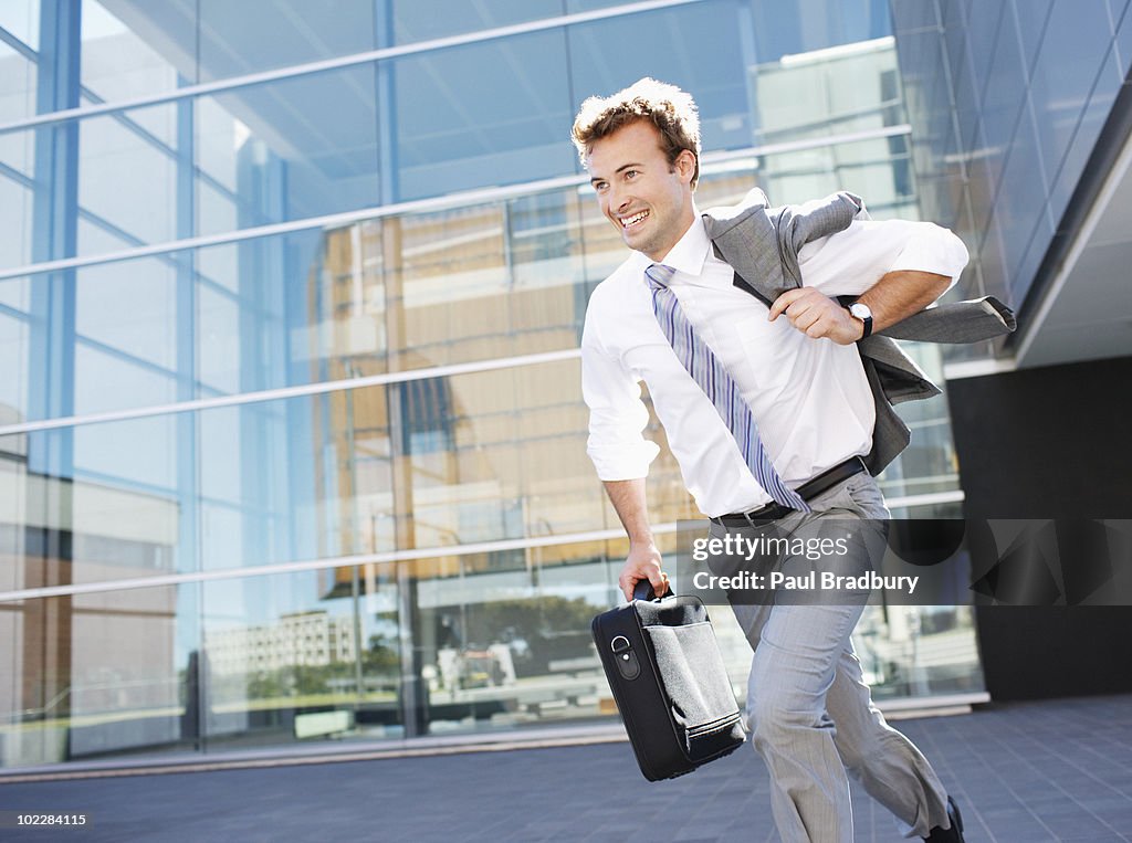 Businessman running with briefcase