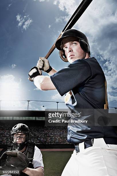 baseball player swinging baseball bat - baseball hit stock pictures, royalty-free photos & images