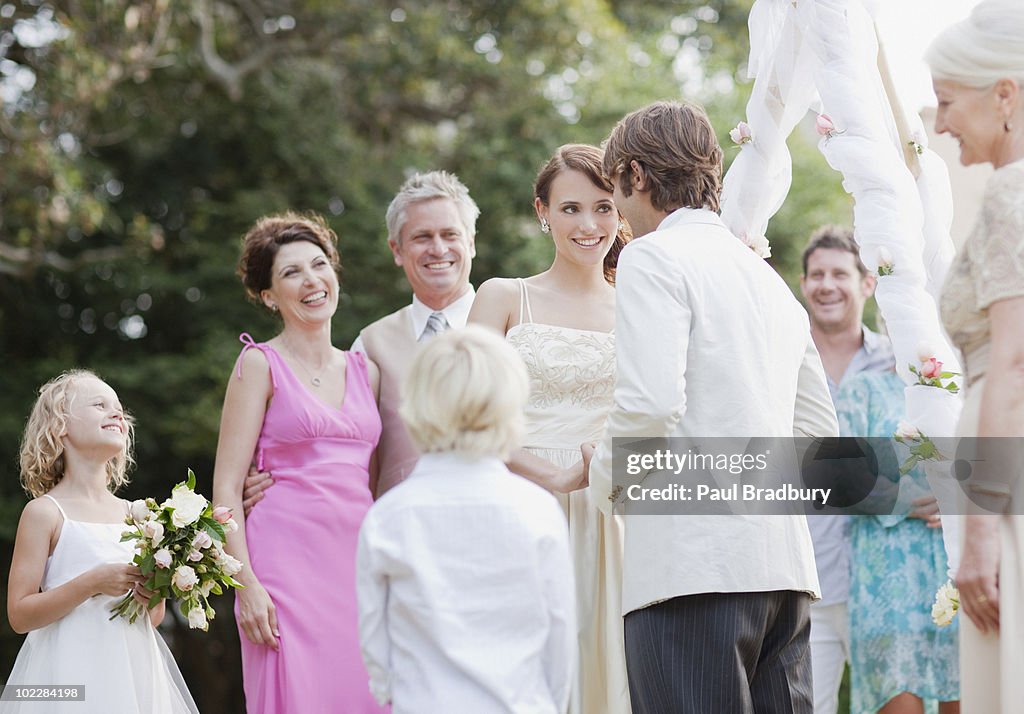 Guests watching bride and groom