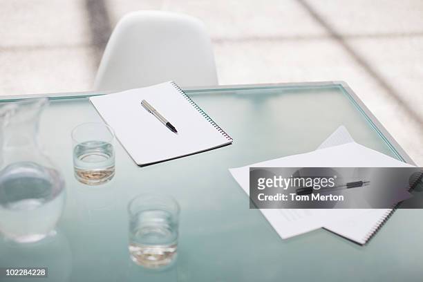 notepads and pens on conference table - notepad table stock pictures, royalty-free photos & images