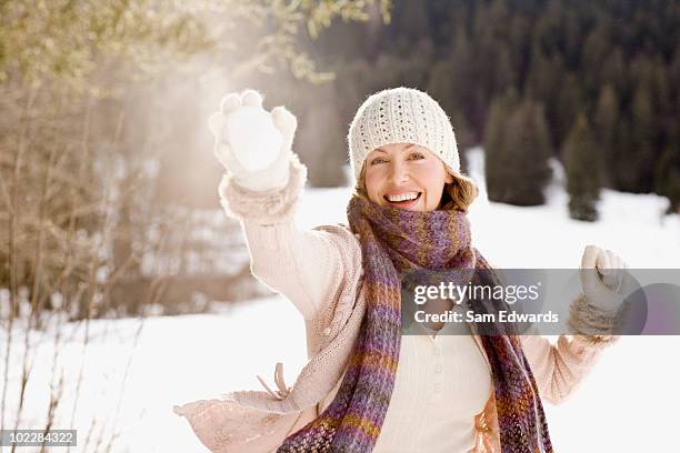 woman holding snowball - women winter snow stock pictures, royalty-free photos & images