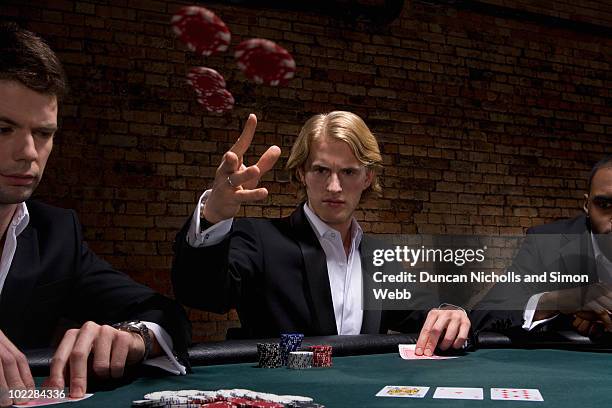 man throwing poker chips in casino - poker stockfoto's en -beelden