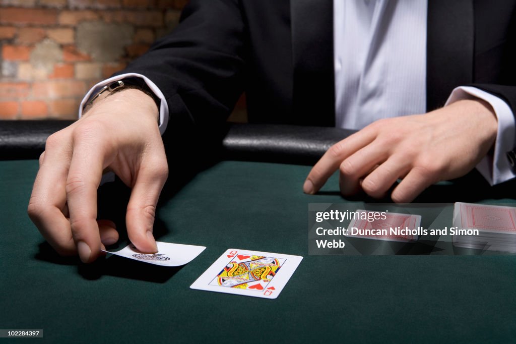 Man playing blackjack in casino