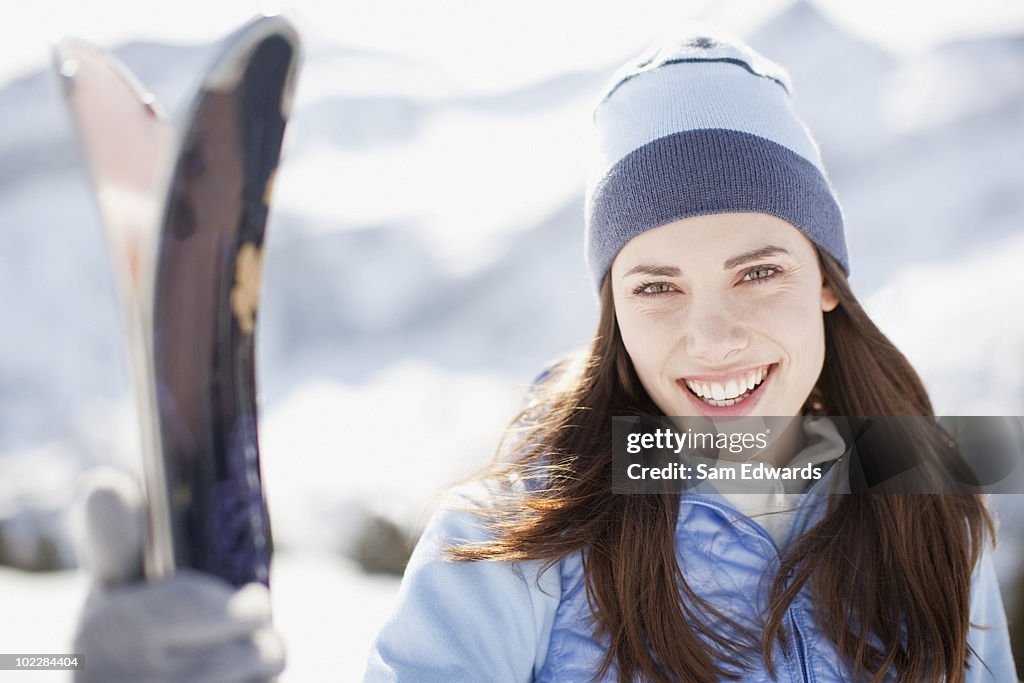 Woman holding skis