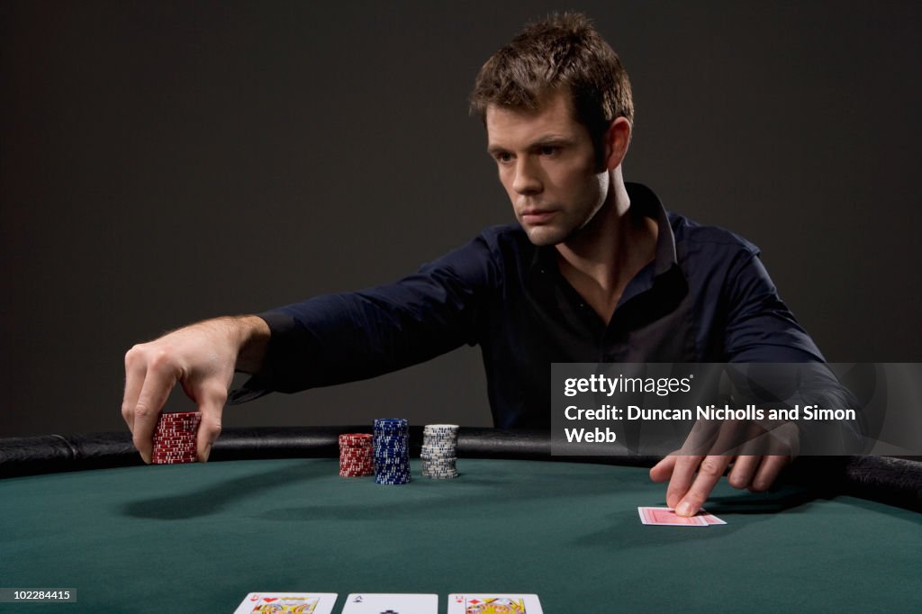 Man playing poker in casino