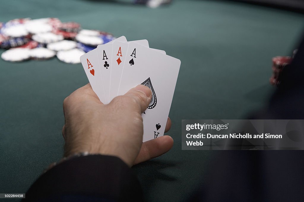 Man with four aces in casino