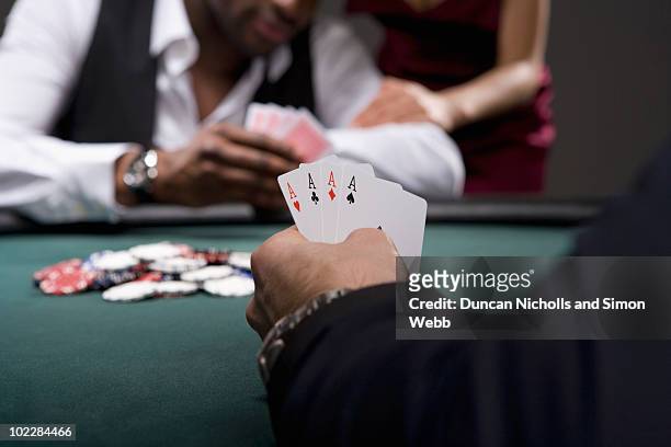 man with four aces in casino - poker table stock pictures, royalty-free photos & images