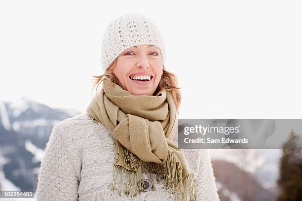 woman in cap and scarf smiling - winter scarf stock pictures, royalty-free photos & images