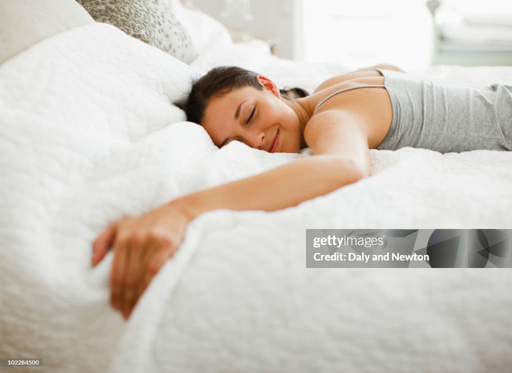 Happy woman laying on bed