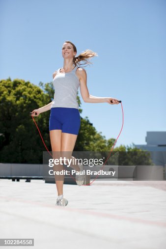 Woman Skipping Rope In Urban Plaza High-Res Stock Photo - Getty Images