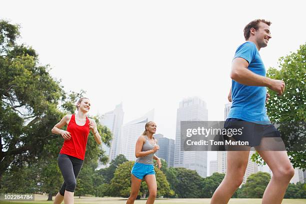 friends running in urban park - tom hale stock pictures, royalty-free photos & images