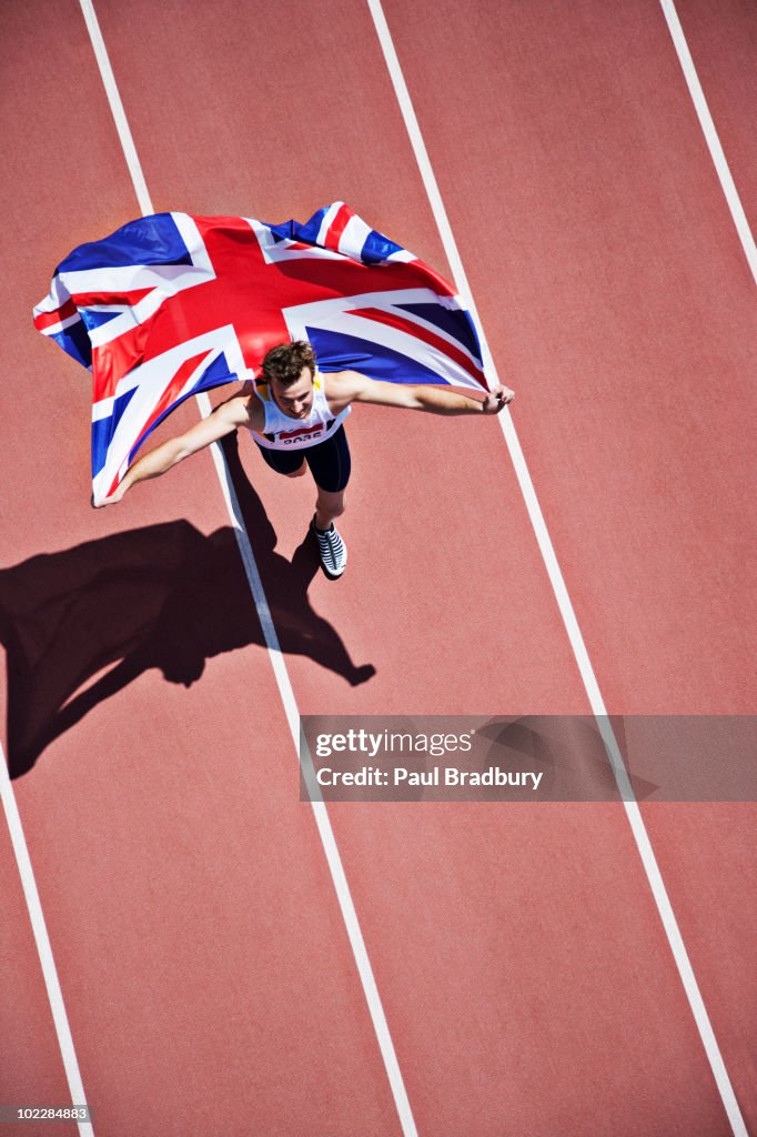 Runner celebrating with British flag on track