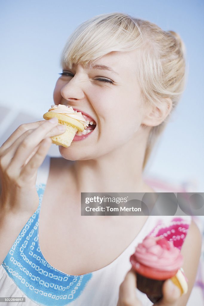 Woman eating cupcake