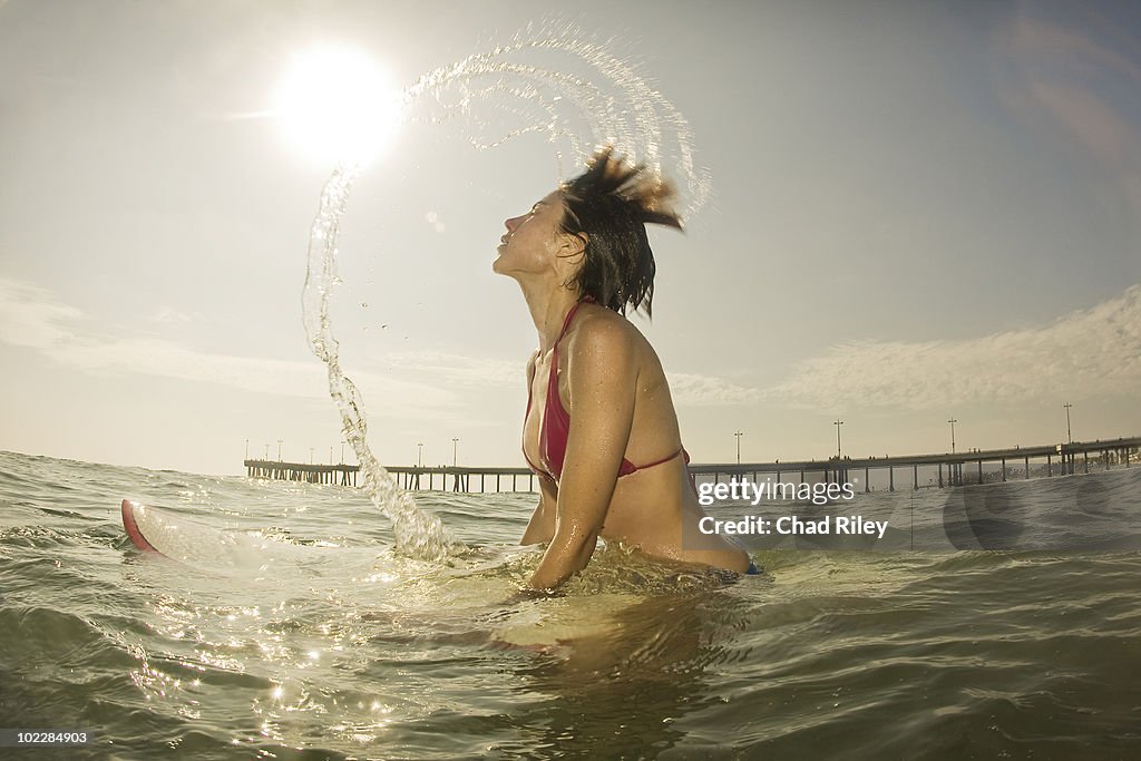 Woman on surfboard in ocean