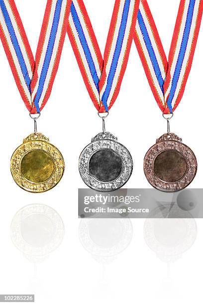 gold, silver and bronze medals - bronzemedaille stockfoto's en -beelden