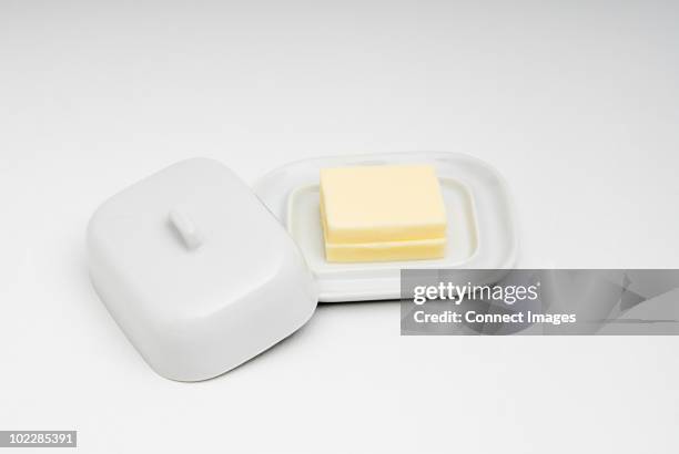 butter in butter dish - lid stock pictures, royalty-free photos & images