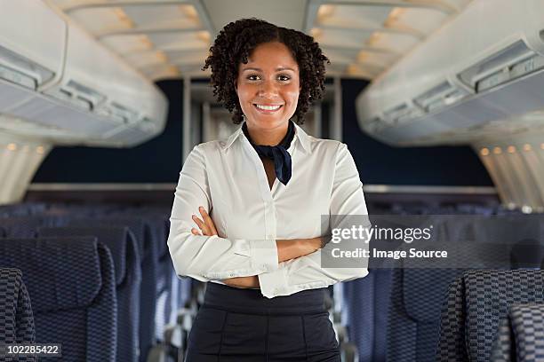 stewardess on airplane - steward stockfoto's en -beelden