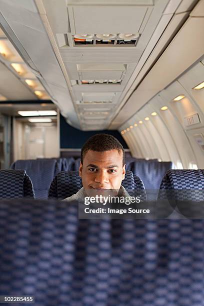 man on an airplane - vliegtuigstoel stockfoto's en -beelden