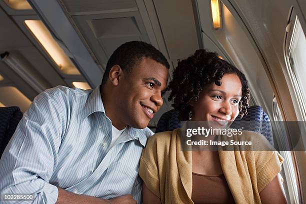 couple on an airplane - couple airplane stockfoto's en -beelden
