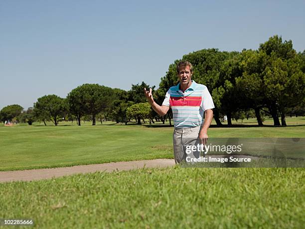 man playing golf, stuck in bunker - angry golfer stock pictures, royalty-free photos & images