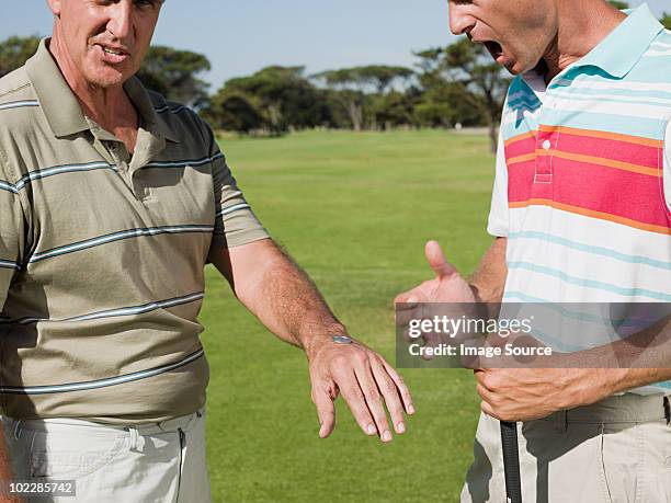 two mature men playing golf together, tossing a coin - angry golfer stock pictures, royalty-free photos & images