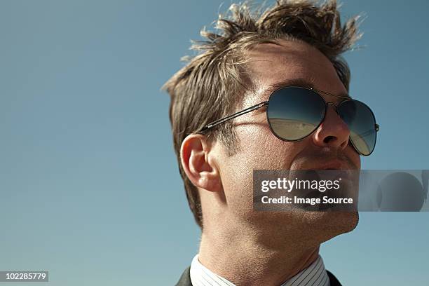 businessman with desert reflected in sunglasses - man sunglasses face imagens e fotografias de stock