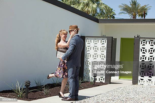 retro couple outside home - 1950s couple stock pictures, royalty-free photos & images