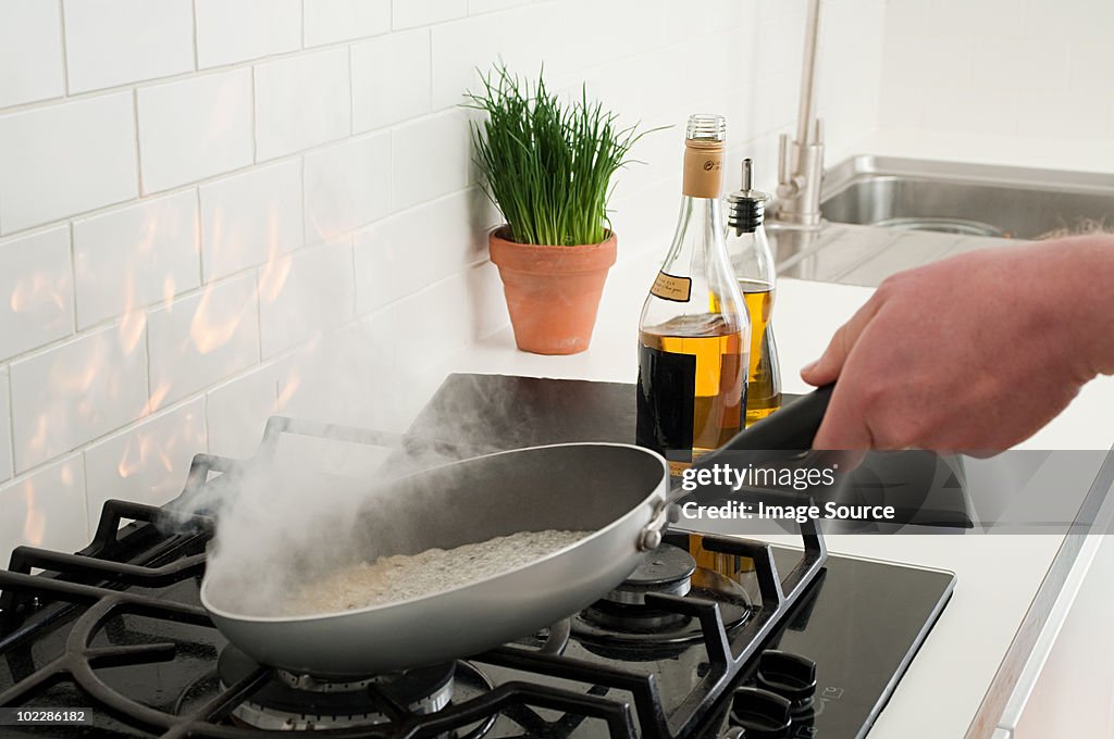 Man using frying pan