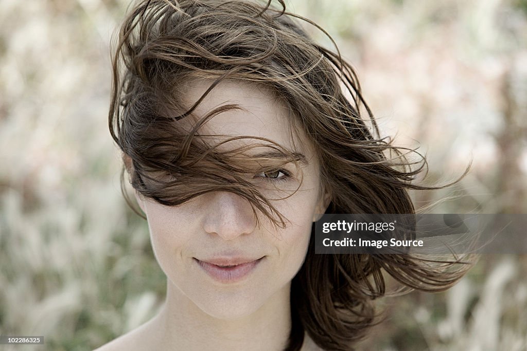 Young brunette woman alone outdoors, portrait