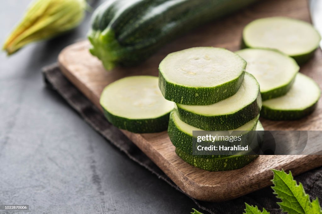 Fresh zucchini on wooden table close up. Copy space.