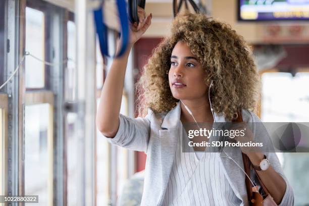 woman using public transportation - commuter bus stock pictures, royalty-free photos & images