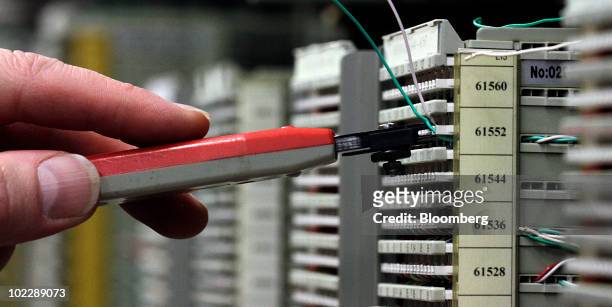Telstra Corp. Employee checks the telephone and broadband mainframe system at an exchange center in Melbourne, Australia, on Tuesday, June 22, 2010....