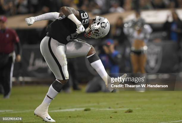 Arden Key of the Oakland Raiders celebrates after he sacked the quarterback against the Green Bay Packers during the second quarter of an NFL...